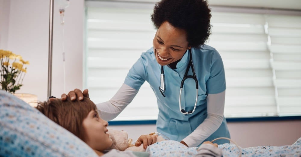 An ICU nurse working with their patient