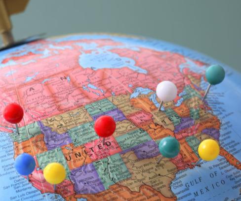 A globe focused on the United States with pins in major cities